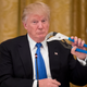 President Trump holding what is presumably the Trumpcare replacement for a proper vasectomy (Photo by Michael Reynolds - Pool/Getty Images)